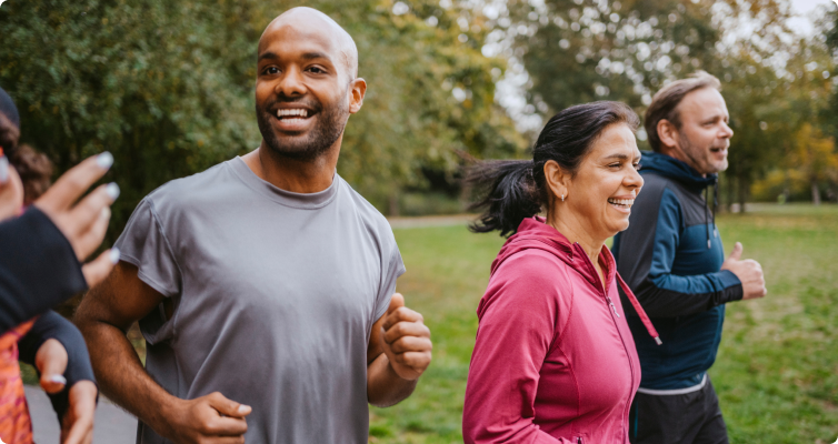 Co-workers out for a run in the park. They look very happy and healthy.