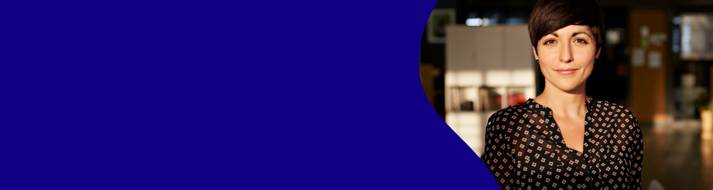 A woman smiles into the camera, her face in full sun