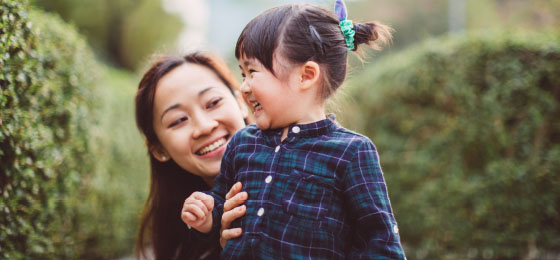 asian woman with child similing