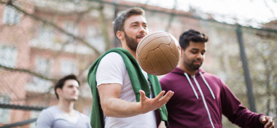 young-men-in-exercise-gear-holding-ball