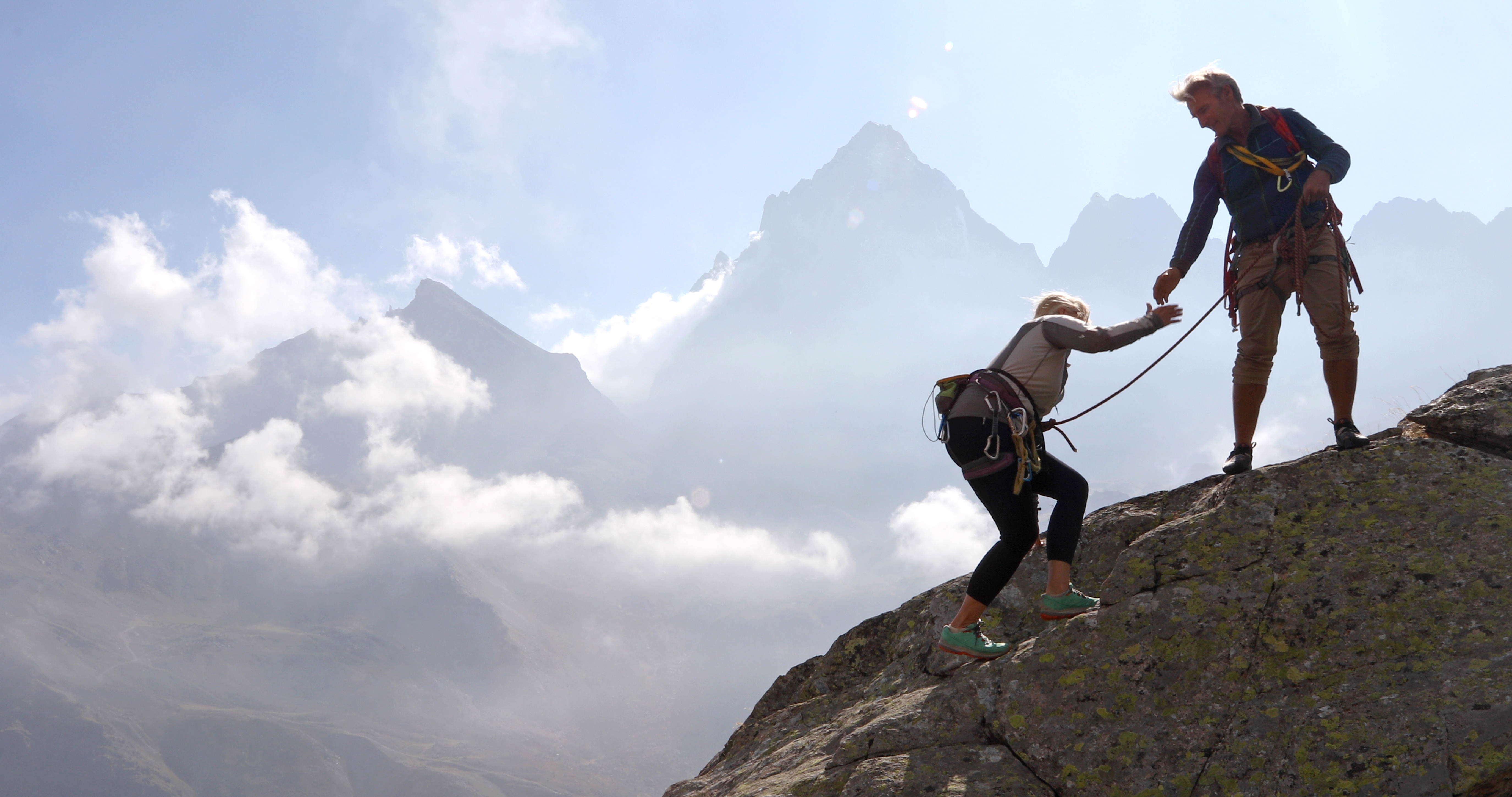 Couple Climbing Mountain