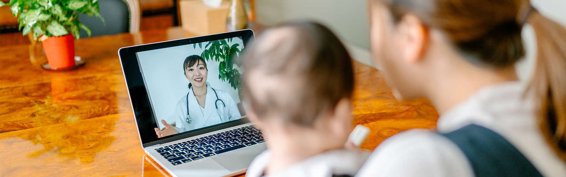 Woman with baby at computer