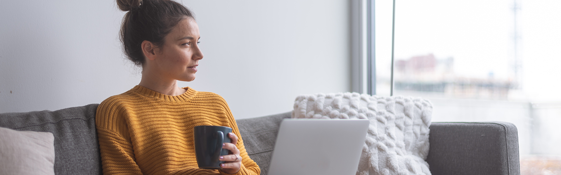 woman on couch with laptop