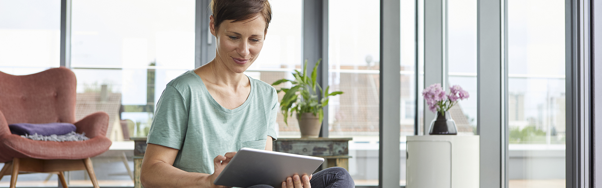 Woman waving at tablet