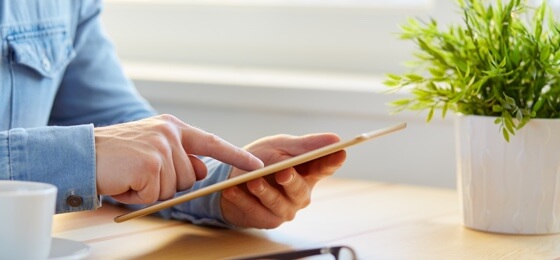 hands holding a tablet