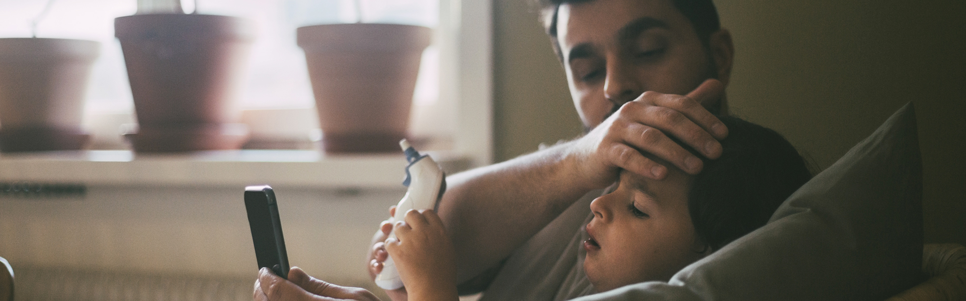 Dad and kid using telehealth