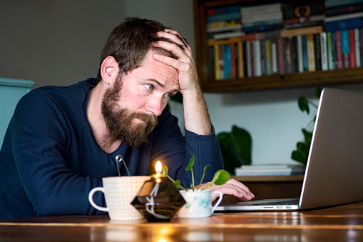 Man at laptop stressed