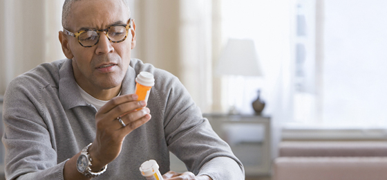 Man with pill bottles